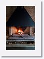 A large fireplace warms the area between the bar and the main dining room