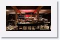 An open kitchen design operates in full view of the dining area
