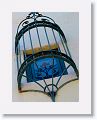 Decorative burglar bars reflected in the upstairs window they guard